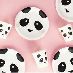 panda face plates and cups on a pink background