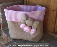 a pink and white bag sitting on top of a brick wall next to a door