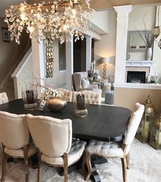 a dining room table and chairs with chandelier