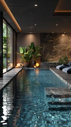 an indoor swimming pool with lounge chairs and potted plants