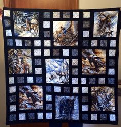 a person holding up a quilt with pictures on it