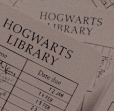 the hogwart's library sign is on top of some papers