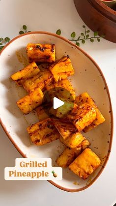 grilled pineapple in a bowl on a plate with the words grilled pineapple