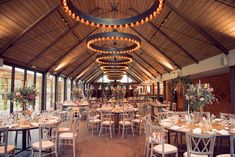 the inside of a restaurant with many tables and chairs set up for an elegant meal