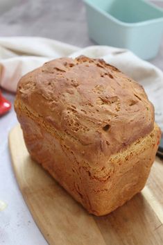 a loaf of bread sitting on top of a wooden cutting board