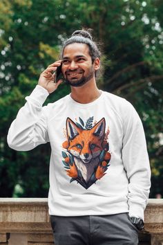 a man wearing a white sweatshirt with an orange fox on it