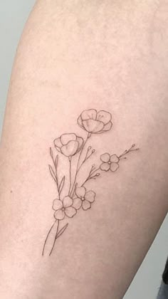 a small flower tattoo on the right side of the thigh, which is black and white