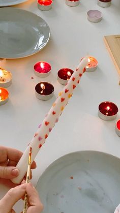 a person lighting candles on a table