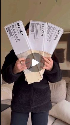 a woman holding four tickets in her hands