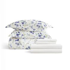 four sheets with blue and white flowers on them, one is folded up to the side