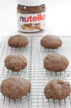 cookies cooling on a rack with nutella in the background