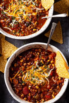 two white bowls filled with chili and cheese