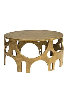 an oval coffee table with holes in the middle and gold paint on it's surface