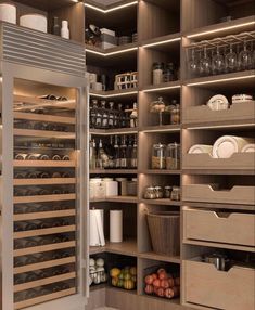 a kitchen pantry filled with lots of food and wine bottles in it's shelves