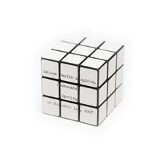 a white and black cube with words written on it's sides, sitting in front of a white background