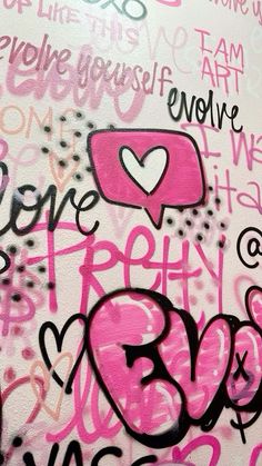 graffiti on the side of a building with pink and black writing that says love is in the air