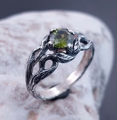 Unique Emerald Stone Elven Style Engagement Ring with Leaves on Branches, Celtic Style Wood Texture Ring, Perfect Gift for Her This is a nature lover's dream. A unique engagement ring created by nature itself, a Silver Branch with great texture and graceful leaves that wrap around your finger, with an Emerald sparkling between them. DETAILS: Stone - 6mm  Metal - recycled solid Sterling Silver Finish - oxidized View all silver branch rings: https://www.etsy.com/shop/TinyShinyJewel?ref=seller-platform-mcnav&section_id=43346778 Care instructions: To care for the ring, avoid contact with water and chemicals such as perfumes and lotions. When the ring is not in use, store it in a dry, cool place to prevent tarnishing. Additional information:  ✦ All rings are made to order. An average turnaround Silver Peridot Jewelry With Center Stone, Fantasy Sterling Silver Jewelry For Anniversary, Engagement Ring With Leaves, Ring With Leaves, Elven Style, Nature Engagement Ring, Branch Ring, Celtic Style, Textured Ring