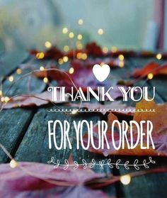 the words thank you for your order are displayed on a wooden table with leaves and lights