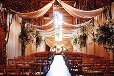 the inside of a barn decorated for a wedding