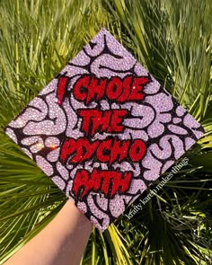 someone is holding up a graduation cap that says i choose the psychic path on it