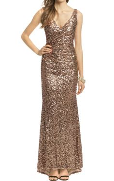 a woman in a gold sequin gown