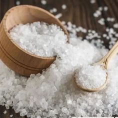 sea salt in a wooden bowl next to a spoon