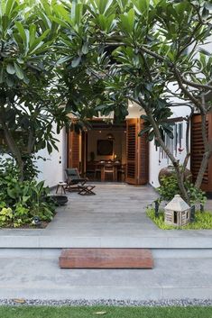 an outdoor living area with chairs and trees