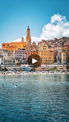 the beach is full of people and buildings