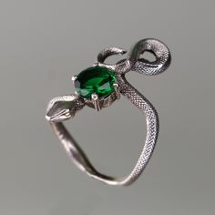 925 Silver Snake Emerald Ring,  925 Sterling Silver Ring, Emerald Snake Silver Ring, Emerald Snake Silver Ring, Animal Snake Jewelry Let's not forget that it is handmade. There may be minor differences. I can work the same ring with other natural Gemstones.  Please contact us to learn about our Gem stone stocks. If you have any questions, please feel free to contact me, we are happy to help. Your jewelry will be packed in a luxury jewelry box ready to be given as a special gift. Visit my shop to Green Snake Ring For Gift, Green Snake Ring Gift, Unique Sterling Silver Snake Ring With Gemstone, Unique Sterling Silver Snake Ring As Gift, Sterling Silver Snake Ring Collectible Symbolic, Sterling Silver Symbolic Snake Ring Collectible, Unique Hand Cast Snake Ring As Gift, Collectible Symbolic Sterling Silver Snake Ring, Unique Hand Cast Snake Ring Gift