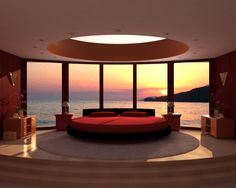 a round bed sitting in the middle of a living room next to a large window