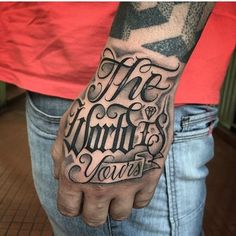 a man with a tattoo on his arm that says, the world is yours in cursive lettering