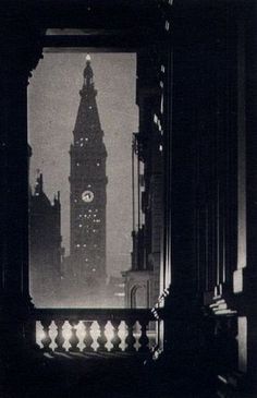 the big ben clock tower towering over the city of london at night, seen through an open window