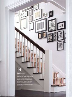 a staircase with many framed pictures on the wall