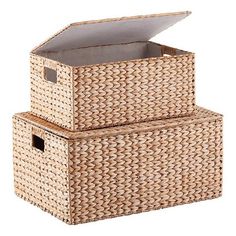 two wicker boxes stacked on top of each other, one with an open lid