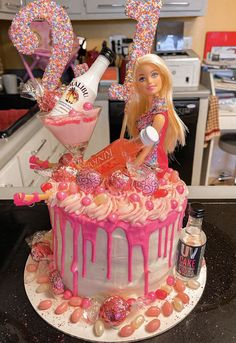 a barbie doll cake with pink icing and sprinkles