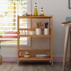 a wooden shelf with dishes and utensils on it in front of a window