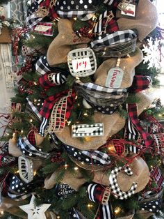 a christmas tree decorated with burlocks and plaid ribbon