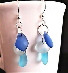 blue and white glass beads hang from silver earwires