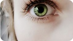 an image of a woman's green eye with long eyelashes