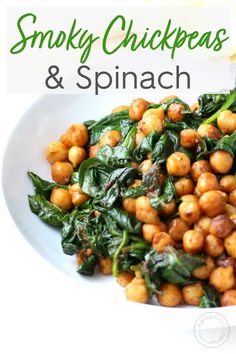 a white plate topped with spinach and chickpeas