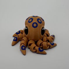 an orange and blue octopus toy sitting on top of a table