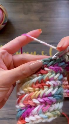 someone is crocheting together with yarn on the table