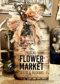 a flower market sign sitting on top of a table