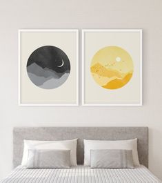 two paintings on the wall above a bed