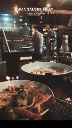 a table topped with plates of food and drinks