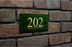 a close up of a brick wall with a sign on it that reads 20 twenty