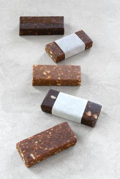 three bars of soap sitting next to each other on top of a white countertop