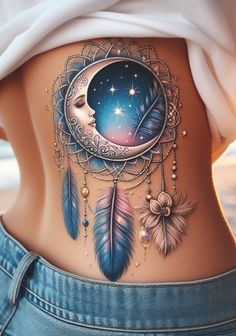 a woman's stomach with an image of a moon, stars and feathers on it