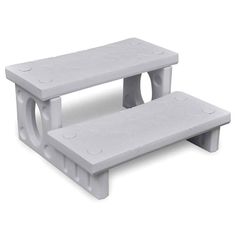 two white benches sitting next to each other