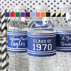 three water bottles with labels on them sitting in front of a black and white background